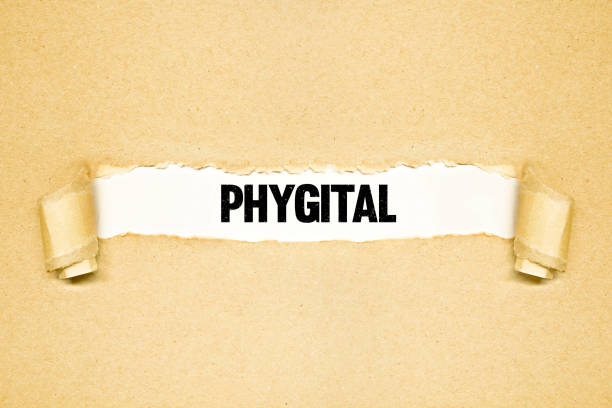 Torn paper revealing words PHYGITAL. Ideas for Shopping online, Banking, Online Business, Finances, Information, Phygital marketing stock photo