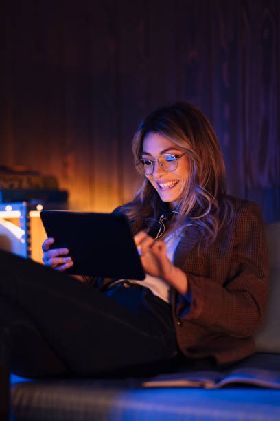 istock Laughing businesswoman using tablet on office couch 1314713833