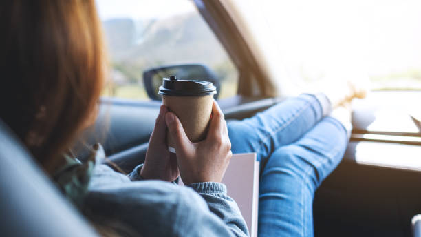 istock A woman drinking coffee while riding the car 1314713919