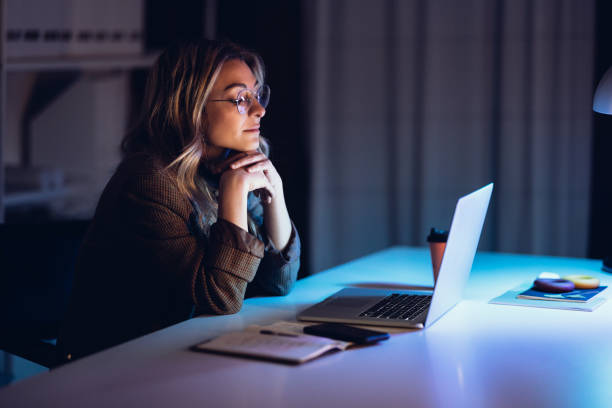 istock Inspired lady with coffee working on laptop in night 1314714055