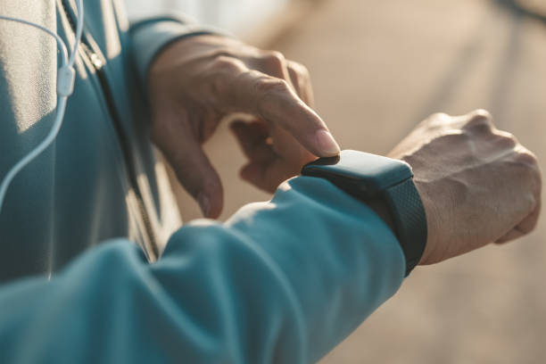 istock sport man checking at smartwatch during training and running in the park. 1314715908