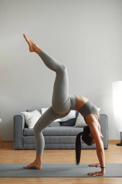 istock Young woman doing yoga at home 1314716074