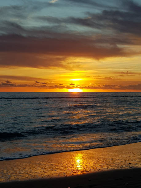 istock Sunset sky over the sand beach by the sea 1314716477