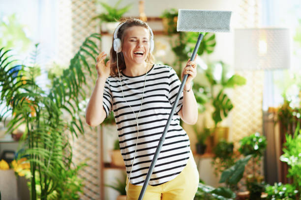 istock smiling woman in sunny day doing household work 1314717767