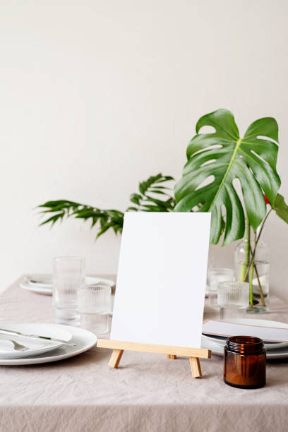istock Mock up table tent, menu or stand for booklet on restaurant table with tropical bouquet 1314719108