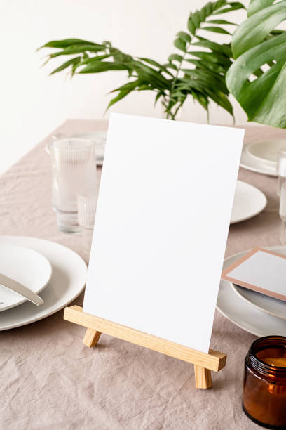 istock Mock up table tent, menu or stand for booklet on restaurant table with tropical bouquet 1314719651