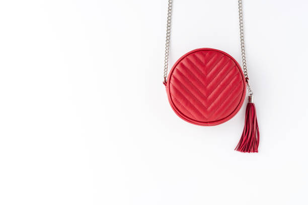 istock Red woman’s purse isolated on white table. Fashion background with copyspace. Top view 1314721483