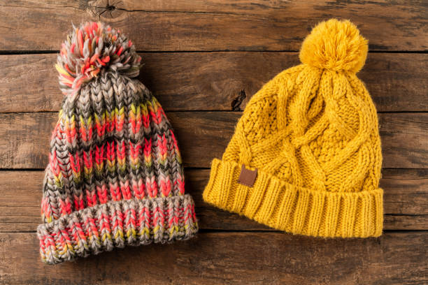 istock Colourful knitted hats on wooden background. Top view 1314722699