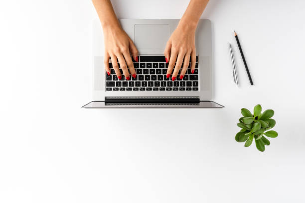 istock Woman’s hands working on laptop. Business background with accessories. Top view 1314723786