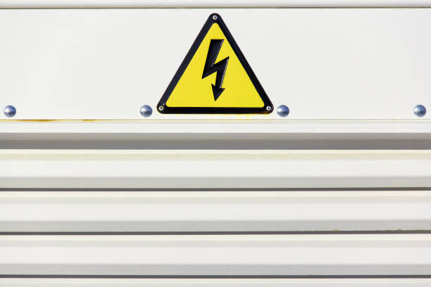 istock Yellow warning sign for high voltage on a gray background. 1314728656