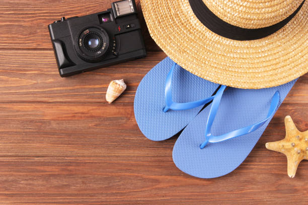 istock travel accessories and tropical leaves on a colored background top view. 1314729522