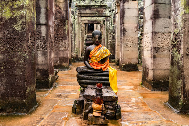 Indian deity statue with yellow sari in Angkor Wat temple