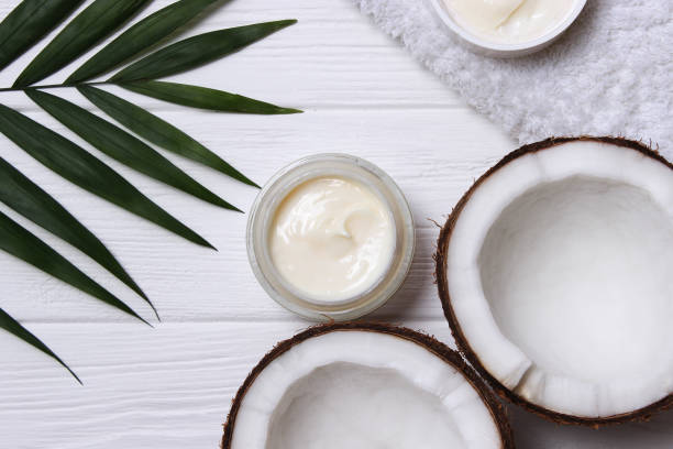 istock Cosmetic jars and coconut on the table close-up and place for text. 1314731589
