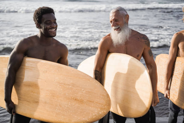 istock Multi generational surfer men having fun on the beach - Main focus on senior face 1314731635