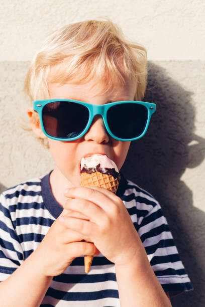 istock Cute Kid Boy Eating Ice Cream 1314733051