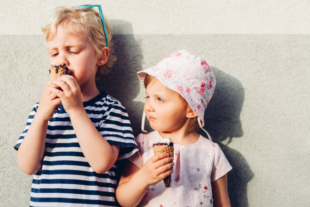 istock Brother And Sister Eating Ice Cream 1314733385
