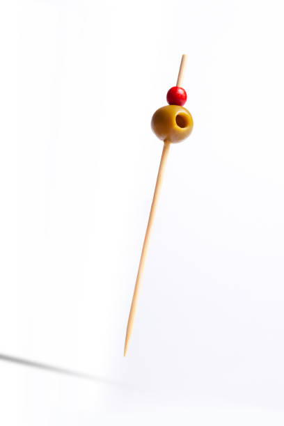 Isolated olives on skewers Isolated olives on skewers with white background banderilla stock pictures, royalty-free photos & images