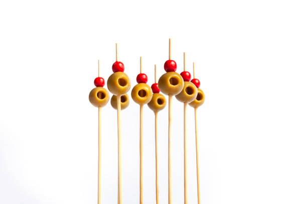 Isolated olives on skewers Isolated olives on skewers with white background banderilla stock pictures, royalty-free photos & images