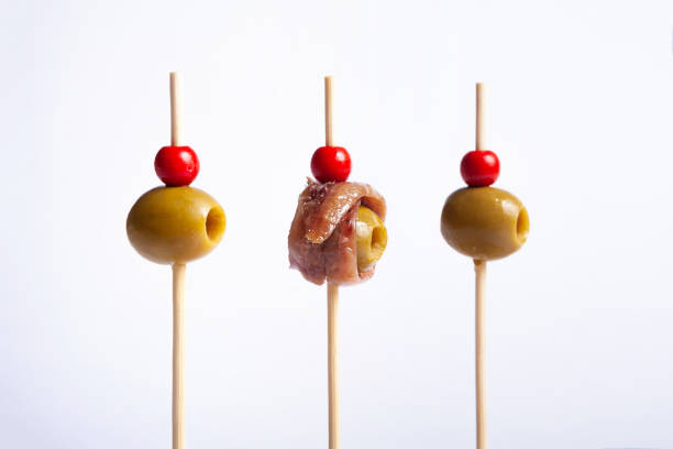 Isolated olives on skewers Isolated olives on skewers with white background banderilla stock pictures, royalty-free photos & images