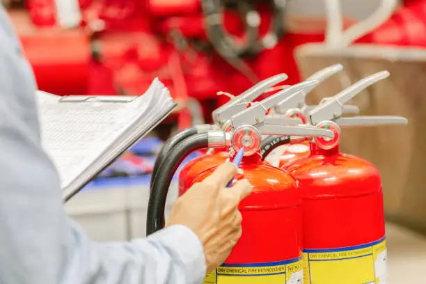 Engineer inspection Fire extinguisher and fire hose,Ready to use in the event of a fire.Safety first concept.