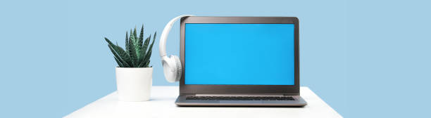 istock Laptop with wireless headphones on white desk 1314737954