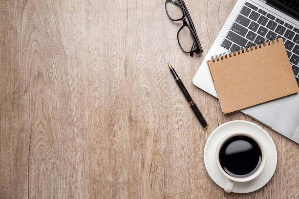 istock Flat lay, top view office table desk. Workspace with, laptop,office supplies, pencil, green leaf, and coffee cup on wood background. 1314737996