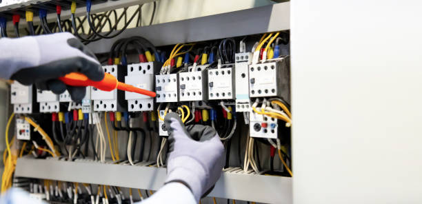 istock Electricians work to connect electric wires in the system, switchboard, electrical system in Control cabinet. 1314738591