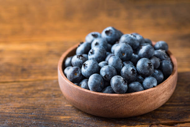 istock Organic blueberries in a wooden bowl 1314739078