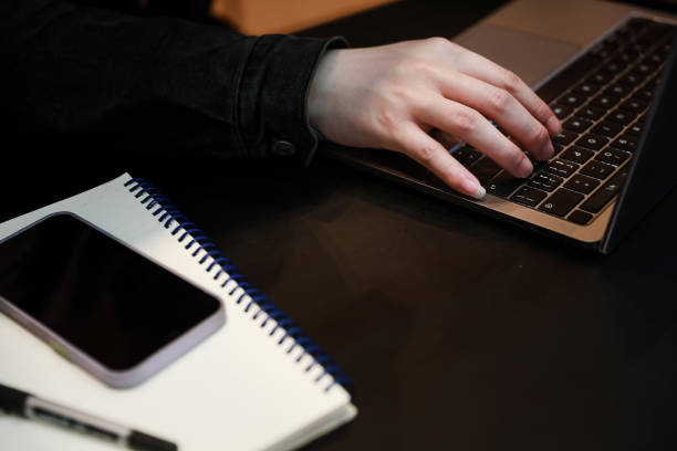 istock Close-up of hands typing on laptop keyboard on table 1314739659