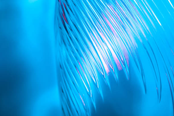 istock Abstract glass background. Texture of wavy glass illuminated with multi-colored light. Pink and blue stains. glass flares. Close up. 1314740727