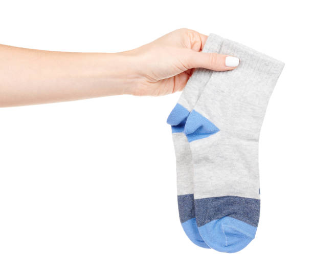 istock Hand with blue cotton socks isolated on white background 1314742946