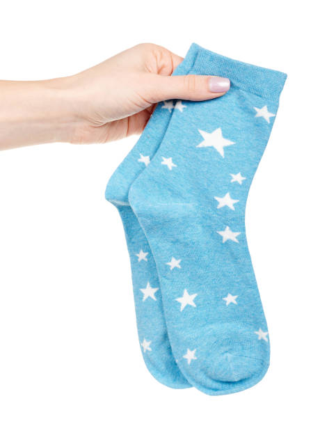 istock Hand with blue cotton socks isolated on white background 1314743177