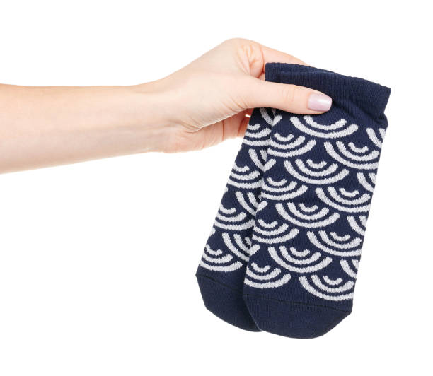 istock Hand with dark blue cotton socks with pattern isolated on white background 1314743185