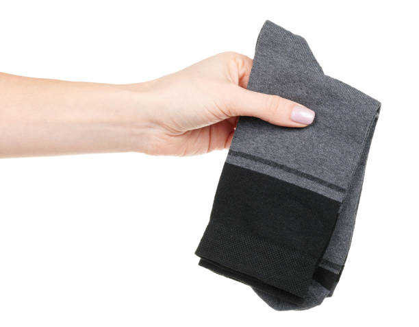 istock Hand with dark cotton socks with pattern isolated on white background 1314743193
