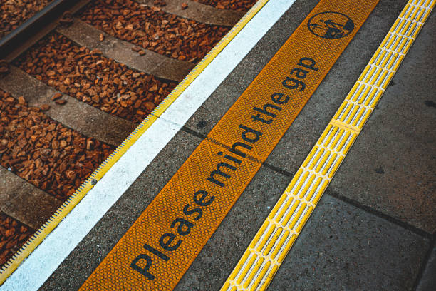 "Please mind the gap" warning sign "Please mind the gap" warning sign gap toothed stock pictures, royalty-free photos & images