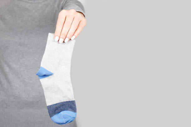 istock Hand with cotton socks on grey background 1314744734