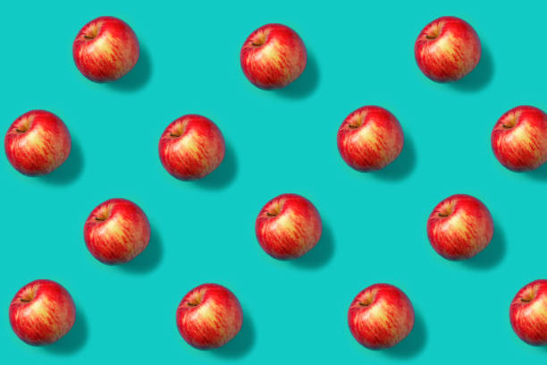 istock Colorful fruit pattern with fresh red apples on vibrant blue background. Minimal food concept. Vegetarian diet banner or vitamin healthy texture. Flat lay, top view. 1314746520
