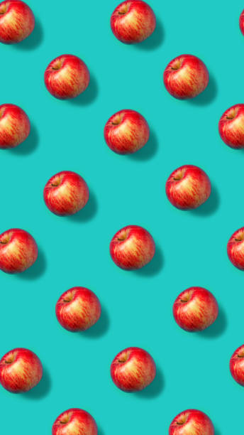 istock Colorful fruit pattern with fresh red apples on vibrant blue background. Minimal food concept. Vegetarian diet banner or vitamin healthy texture. Flat lay, top view. 1314746914