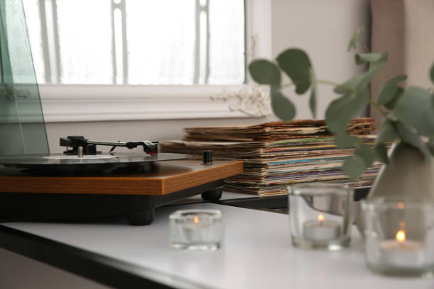 istock Stylish turntable with vinyl record on table indoors 1314748347