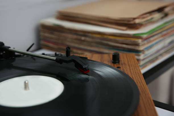 istock Stylish turntable with vinyl record on table, closeup 1314748520