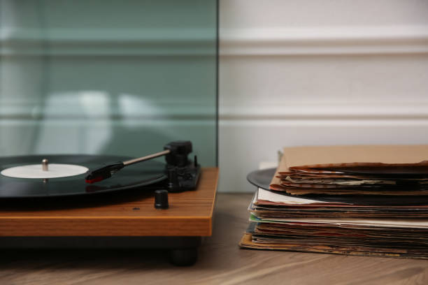 istock Stylish turntable with vinyl records on floor indoors 1314749288