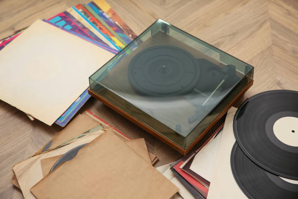 istock Stylish turntable with vinyl records on floor 1314749880