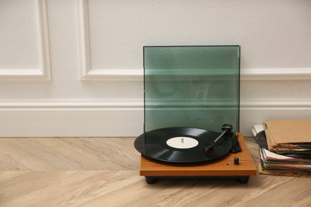 istock Stylish turntable and vinyl records on floor indoors, space for text 1314750848