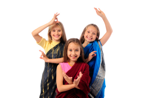 girls dancing, dressed in traditional Indian attire