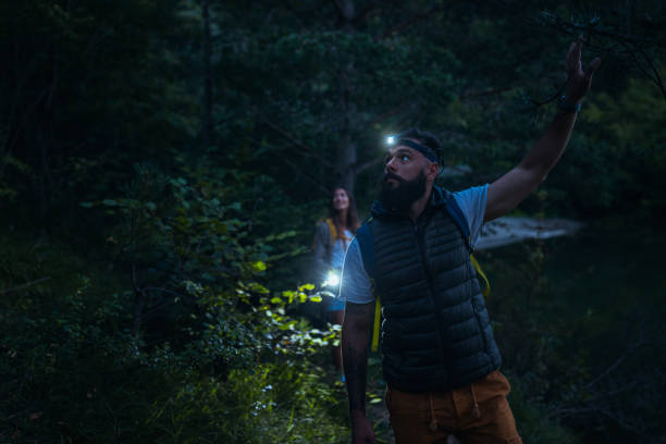istock Young couple with backpackers exploring nature at night 1314753948