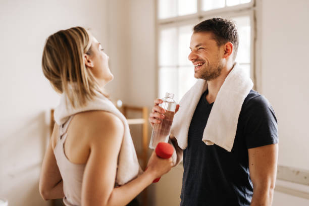 istock Happy young couple laughing while working out at home 1314754580