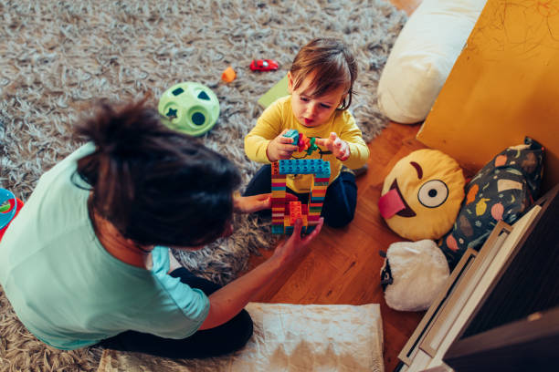 istock Mother playing with son with toy blocks 1314757598