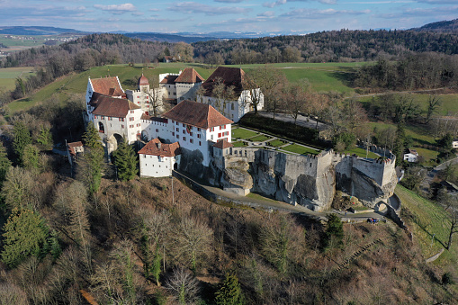 Owen, Germany - June 11, 2023: XXXL Panorama of the Swabian Alb in Baden Württemberg in Summer. Drone view over the green summer Swabian Alb Hill Range. Burg Teck - Teck Castle on top of green hill illuminated from sunset light. Stitched XXXL Panorama DJI Mavic 3 Pro. Teck Castle, Owen, Swabian Alb, Baden Württemberg, Southern Germany, Germany, Europe.