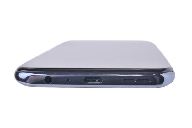 istock The end part of the smartphone on which there is a charging socket, a microphone, a headphone input and speakers. On a white background, close-up 1314760801