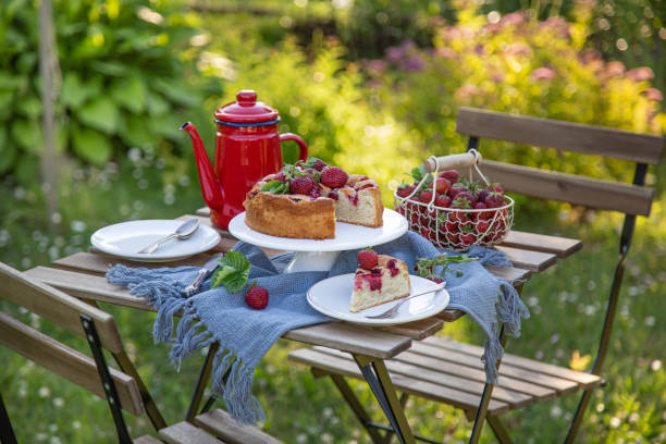 istock Table setting with summer strawberry cake in a garden 1314761096